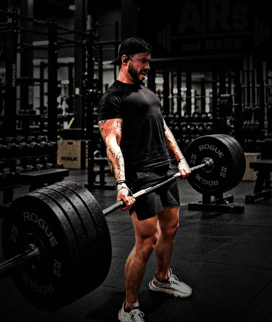 Coach Shep deadlifting a loaded barbell